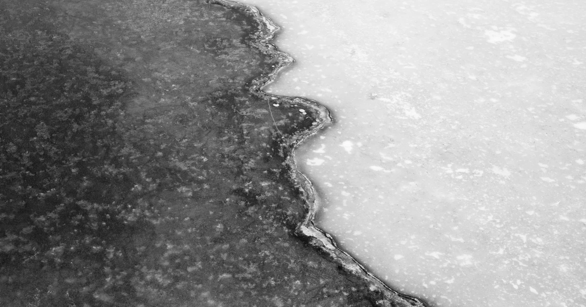 Ice boundary between dark and light surfaces, representing division, ambiguity, and moral certainty in therapy and politics